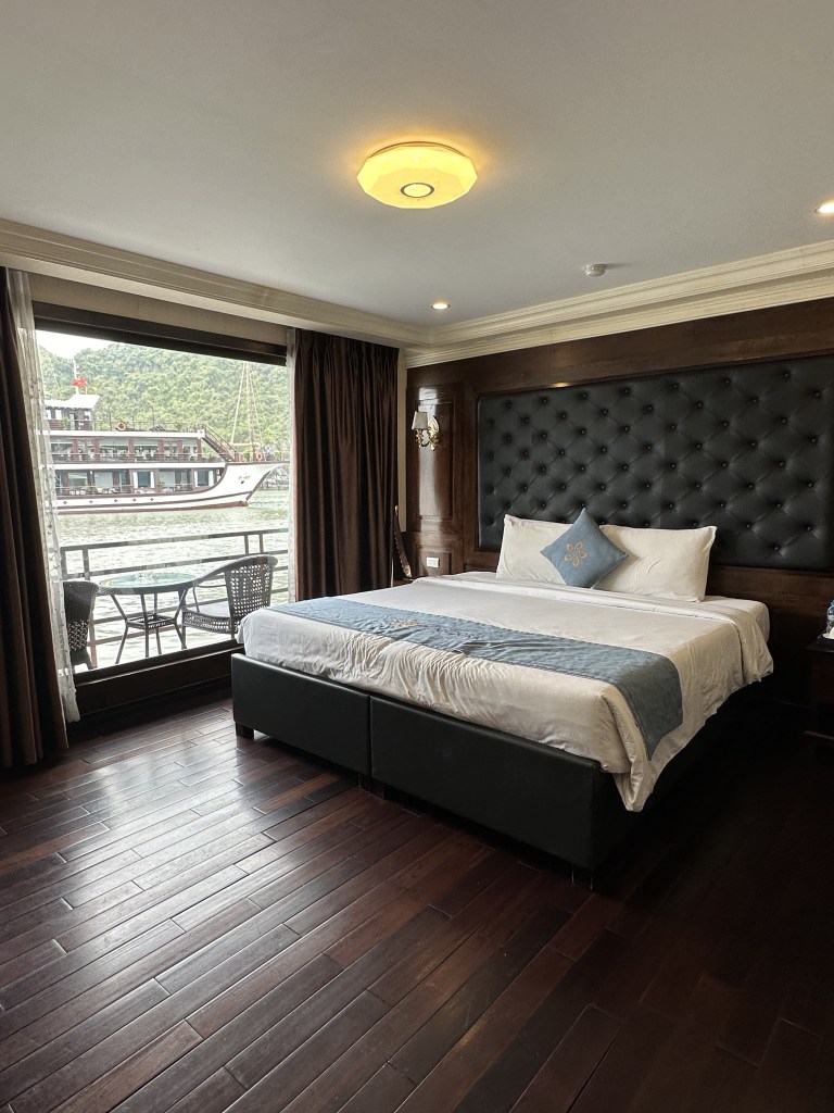 Cozy stateroom aboard La Pandora featuring a comfortable king bed, tastefully decorated with elegant furnishings and warm lighting, creating a welcoming atmosphere for relaxation.